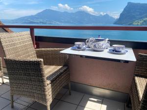 a table with a tea set on top of a balcony at Apartment Apartment 360 by Interhome in Lucerne