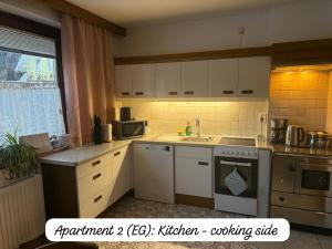 a kitchen with white cabinets and a stove top oven at Angi's Apartment in Sankt Lorenzen ob Murau