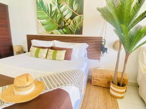 a bedroom with a bed with a hat on it at Excellence Suites Orient Beach Oceanview King-Size Beach Pool Parking in Cul de Sac