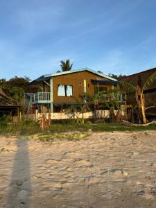 a house sitting on top of a beach at Seaside Blue Inn in San Vicente