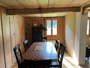 a dining room with a table and chairs at Apartment Lungern by Interhome in Lungern