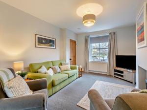 a living room with a couch and a tv at 2 Bed in Keswick oc-sz006 in Keswick