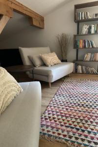 a living room with a couch and a rug at Apartment Sunnehöckli by Interhome in Hasliberg +9 photos