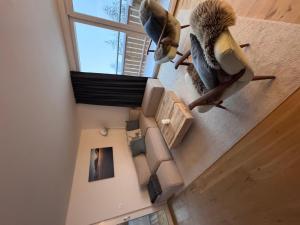 an overhead view of a living room with a couch and a window at Apartment Sunnehöckli by Interhome in Hasliberg