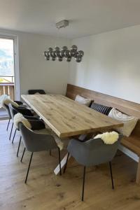 a dining room with a wooden table and chairs at Apartment Sunnehöckli by Interhome in Hasliberg
