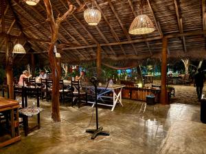 a camera on a tripod in a restaurant with lights at Valampuri Kite Resort in Kalpitiya