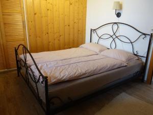 a bed with a metal frame in a room at Apartment Haus Brog by Interhome in Rohrmatten
