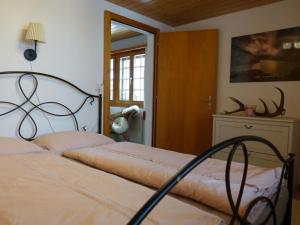 a bedroom with a bed with a metal head board at Apartment Haus Brog by Interhome in Rohrmatten