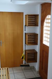 a room with wooden shelves and a door at Apartment Haus Brog by Interhome in Rohrmatten +2 photos