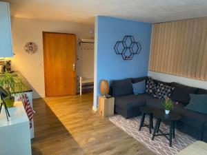 a living room with a couch and a table at Apartment Spring Inn Studio by Interhome in Rohrmatten