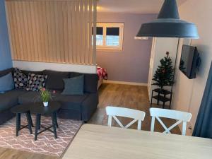 a living room with a couch and a table and chairs at Apartment Spring Inn Studio by Interhome in Rohrmatten