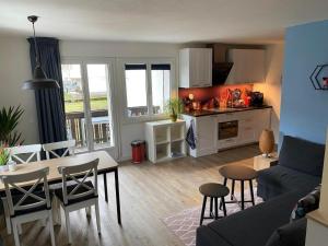 a kitchen and living room with a table and chairs at Apartment Spring Inn Studio by Interhome in Rohrmatten +7 photos