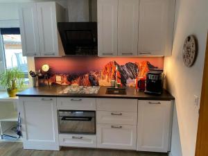 a kitchen with white cabinets and a counter top at Apartment Spring Inn Studio by Interhome in Rohrmatten