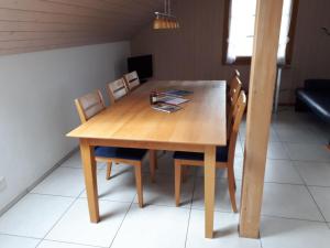 a wooden table and chairs in a room at Apartment Gmünde by Interhome in Schüpfheim