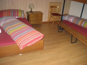 a room with two beds and a wooden floor at Apartment Gmünde by Interhome in Schüpfheim