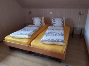 two beds in a small room with at Apartment Gmünde by Interhome in Schüpfheim +10 photos