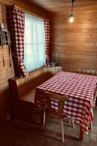 a dining room with a table in a cabin at Apartment Chalet Bacchus - EG by Interhome in Sörenberg +9 photos