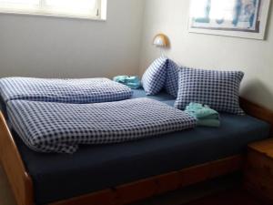 two pillows sitting on a bed in a room at Apartment Baldo by Interhome in Sörenberg