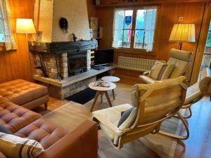 a living room with a couch and a fireplace at Holiday Home Chalet Glücksfall by Interhome in Bellwald