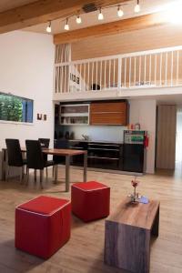a large living room with a table and a kitchen at Apartment Lauigrund by Interhome in Sörenberg +5 photos