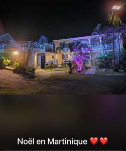 a picture of a house with christmas lights at Villa Boat red in Quartier Morne Acajou