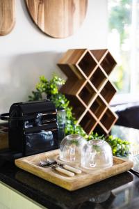 a cutting board with wine glasses on a counter at Shekinah Cabin in Hartbeespoort +15 photos