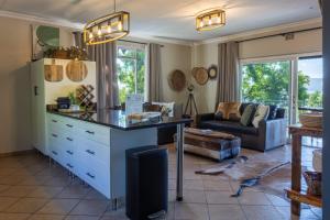 a kitchen and living room with a table and a couch at Shekinah Cabin in Hartbeespoort