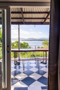 a balcony with a view of the water at Shekinah Cabin in Hartbeespoort