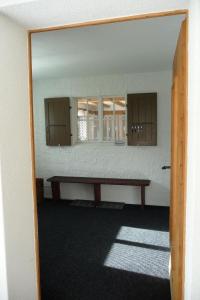 an empty room with a table and a mirror at Apartment Saturn by Interhome in Sörenberg