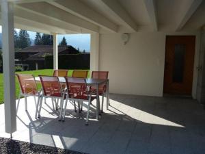 a table and chairs sitting on a patio at Apartment Saturn by Interhome in Sörenberg