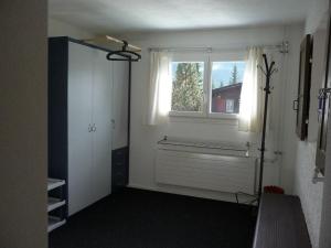 an empty room with a window and a closet at Apartment Saturn by Interhome in Sörenberg