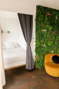 a bedroom with a bed and a green wall at Studio au Cœur des Sommets in Crans-Montana