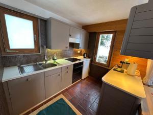 a small kitchen with a sink and a counter at Apartment Rothornblick by Interhome in Sörenberg
