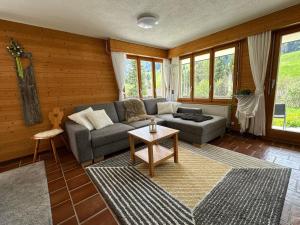a living room with a couch and a table at Apartment Rothornblick by Interhome in Sörenberg
