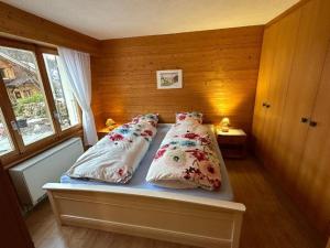 a bedroom with two beds with pillows on it at Apartment Rothornblick by Interhome in Sörenberg