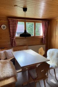 a dining room with a table and a window at Apartment Chalet Bacchus - OG by Interhome in Sörenberg