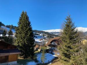 an aerial view of a resort with snow covered mountains at Apartment Chalet Bacchus - OG by Interhome in Sörenberg