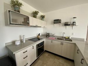 a kitchen with white cabinets and a sink at LUMINARIA Pool, Near the Historic Center | Elegant in San Miguel de Allende