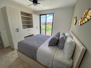 a bedroom with a bed with pillows and a window at LUMINARIA Pool, Near the Historic Center | Elegant in San Miguel de Allende +39 photos