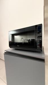 a microwave oven sitting on top of a counter at Duplex completo, perto da praia e no centro de Imbé in Imbé