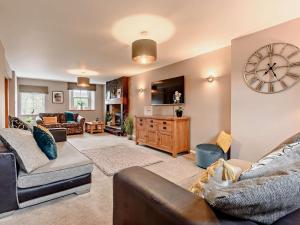 a living room with a large clock on the wall at 3 Bed in Egremont oc-90050 in Hale