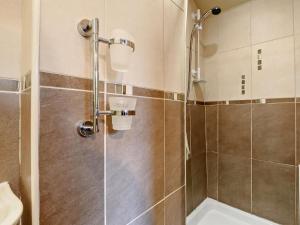 a shower with a glass door in a bathroom at 3 Bed in Egremont oc-90050 in Hale +23 photos