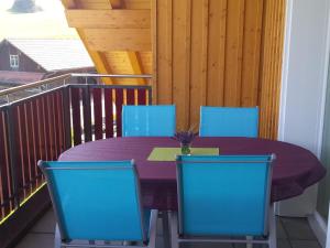 a purple table and chairs on a balcony at Apartment S'Ottä by Interhome in Sattel
