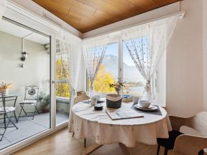 a dining room with a table and a large window at Apartment Lake View Studio by Interhome in Ingenbohl
