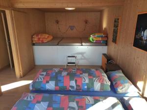 a small room with a bed and a couch at Apartment Chalet Hörler direkt im Ski- und Wandergebiet by Interhome in Emmetten