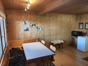 a room with a table and chairs and a refrigerator at Apartment Chalet Hörler direkt im Ski- und Wandergebiet by Interhome in Emmetten +31 photos