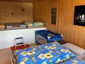a bedroom with a bed and two bunk beds at Apartment Chalet Hörler direkt im Ski- und Wandergebiet by Interhome in Emmetten