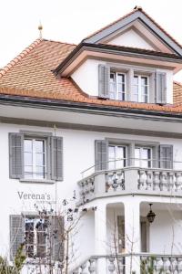 a white house with a balcony at Holiday Home Verena's B&B by Interhome in Sachseln