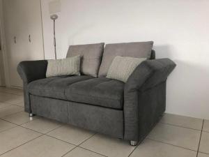 a brown couch sitting in a living room at Apartment Studio Rubi Weggis by Interhome in Weggis
