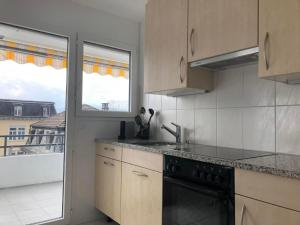 a kitchen with a sink and a stove at Apartment Studio Rubi Weggis by Interhome in Weggis